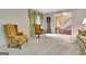 Bright living room featuring neutral carpet, classic furnishings, and an open doorway at 550 Hawthorne Dr, Fayetteville, GA 30214