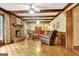 Spacious living room with hardwood floors, brick fireplace, wood beams, and ample natural light at 550 Hawthorne Dr, Fayetteville, GA 30214