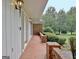 Exterior walkway featuring brick flooring, brick accents, wall lantern lighting and side entrance at 550 Hawthorne Dr, Fayetteville, GA 30214
