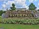 Landscaped waterfall feature with 'WATERFALL' spelled out in large gold letters at 550 Hawthorne Dr, Fayetteville, GA 30214