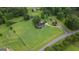 Aerial view of a home on a large, well-maintained lawn with a white fence, showcasing privacy and space at 10 Wigwam Cir, Whitesburg, GA 30185