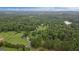 Expansive aerial view showcasing a serene, wooded lot with scattered homes, offering privacy and natural beauty at 10 Wigwam Cir, Whitesburg, GA 30185