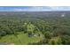 Breathtaking aerial view of the property, revealing its vast, wooded surroundings and serene location at 10 Wigwam Cir, Whitesburg, GA 30185