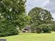 Expansive backyard with a covered patio area and mature trees for privacy at 10 Wigwam Cir, Whitesburg, GA 30185