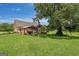 Expansive lawn with a covered patio and view of the brick home at 10 Wigwam Cir, Whitesburg, GA 30185