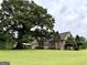 Sprawling backyard showcases the home's architecture and extensive green space at 10 Wigwam Cir, Whitesburg, GA 30185