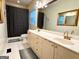 Well-lit bathroom with double vanity, framed mirrors, and tiled floor at 10 Wigwam Cir, Whitesburg, GA 30185