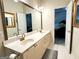 This bathroom boasts a double sink vanity, neutral color palette, and a large mirror, creating a bright and functional space at 10 Wigwam Cir, Whitesburg, GA 30185