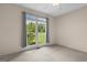 Bedroom with large window overlooking green yard at 10 Wigwam Cir, Whitesburg, GA 30185