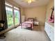 This bedroom features a large window that provides plenty of natural light, creating a warm and inviting atmosphere at 10 Wigwam Cir, Whitesburg, GA 30185