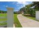 Long, paved driveway leading to a brick home with an attached garage and well-manicured lawn at 10 Wigwam Cir, Whitesburg, GA 30185