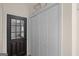Inviting entryway featuring a stylish black door, practical coat closet, and decorative wall art at 10 Wigwam Cir, Whitesburg, GA 30185