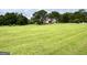 Sprawling estate with a well-maintained lawn, mature trees, and a picturesque home nestled amidst the serene landscape at 10 Wigwam Cir, Whitesburg, GA 30185