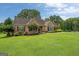 Well-maintained brick home with a manicured lawn, tasteful landscaping, and inviting curb appeal at 10 Wigwam Cir, Whitesburg, GA 30185