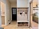 Mudroom with built-in storage bench, hooks, and shelving, offering practical organization and seamless transition to the kitchen at 10 Wigwam Cir, Whitesburg, GA 30185