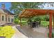 Outdoor patio with covered seating, perfect for entertaining and enjoying the surrounding landscaped yard at 10 Wigwam Cir, Whitesburg, GA 30185