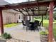 Outdoor patio features a dining set under a covered structure with string lights at 10 Wigwam Cir, Whitesburg, GA 30185