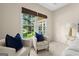 This primary suite features a sitting area with serene backyard views at 10 Wigwam Cir, Whitesburg, GA 30185