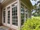 Bright sunroom with natural light, multiple windows, and views of the landscaped backyard at 10 Wigwam Cir, Whitesburg, GA 30185