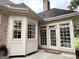 Bright sunroom with large windows and neutral tones, leading to outdoor patio at 10 Wigwam Cir, Whitesburg, GA 30185