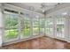 Sunroom with tile flooring, surrounded by large windows offering views of the lush landscape at 10 Wigwam Cir, Whitesburg, GA 30185