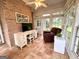Bright sunroom features a brick accent wall, tiled flooring, and plenty of natural light at 10 Wigwam Cir, Whitesburg, GA 30185