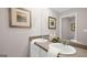 Well-lit bathroom featuring double sinks, neutral decor, and a large mirror for a spacious feel at 351 Friendship Oak Way, Hampton, GA 30228