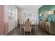 Bright dining room with wood floors, white table, and stylish decor for elegant Gathering meals at 351 Friendship Oak Way, Hampton, GA 30228