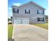 Two-car garage with a wide driveway and landscaped front yard offering ample parking at 351 Friendship Oak Way, Hampton, GA 30228