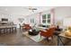 Open-concept living room featuring a ceiling fan, hardwood flooring and bright, natural light at 351 Friendship Oak Way, Hampton, GA 30228