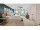 Serene main bedroom with a blue accent wall, ceiling fan, and an adjoining bathroom at 351 Friendship Oak Way, Hampton, GA 30228