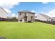 Expansive backyard showcasing lush green lawn and a view of the rear exterior of the home at 372 Cobblestone Trl, Dallas, GA 30157