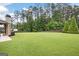 Green backyard featuring mature trees and landscaping for privacy and a serene outdoor space at 372 Cobblestone Trl, Dallas, GA 30157