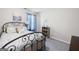 Cozy bedroom with an iron bed frame, soft carpet, and a calming blue accent wall at 372 Cobblestone Trl, Dallas, GA 30157