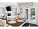 Cozy dining area with table setting and adjacent access to the outdoor patio at 372 Cobblestone Trl, Dallas, GA 30157