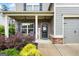 Inviting front porch with brick accents, rocking chairs, and a 'Welcome' sign, enhancing the home's curb appeal at 372 Cobblestone Trl, Dallas, GA 30157