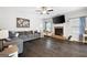 Spacious living room with dark hardwood floors, a cozy fireplace, and ample seating, perfect for relaxation and entertainment at 372 Cobblestone Trl, Dallas, GA 30157