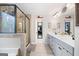 Elegant main bathroom with double vanity, large mirror, and glass-enclosed shower at 372 Cobblestone Trl, Dallas, GA 30157