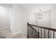 Well-lit staircase with neutral carpet and an elegant chandelier at 372 Cobblestone Trl, Dallas, GA 30157