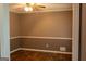 Empty room featuring neutral walls, wood flooring, a ceiling fan, and white trim at 2763 Hunters Ct, Hampton, GA 30228