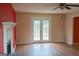 Bright living room features wood flooring, fireplace, and French doors at 2763 Hunters Ct, Hampton, GA 30228