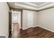 Bedroom featuring wood flooring and tray ceiling at 8330 N Sterling Lakes Dr, Covington, GA 30014