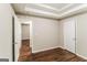 Bedroom featuring wood flooring and tray ceiling at 8330 N Sterling Lakes Dr, Covington, GA 30014