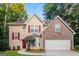 Charming two-story home with stone accents, red shutters, and a well-manicured lawn at 8330 N Sterling Lakes Dr, Covington, GA 30014