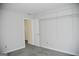 Spacious bedroom with open door, carpeted floor, closet system for storage at 3700 Newhalem Sw St, Atlanta, GA 30331