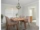 Elegant dining room with a modern chandelier and a large window with natural light at 3700 Newhalem Sw St, Atlanta, GA 30331