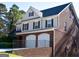 Brick-accented, two-story house with a two-car garage and landscaped entrance at 3700 Newhalem Sw St, Atlanta, GA 30331