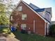 Brick house back view with green yard, AC, and many windows at 3700 Newhalem Sw St, Atlanta, GA 30331