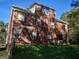 Back view of a brick house showing the yard, AC, and covered patio at 3700 Newhalem Sw St, Atlanta, GA 30331