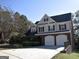 Well-maintained two-story home with a spacious driveway and manicured front yard at 3700 Newhalem Sw St, Atlanta, GA 30331